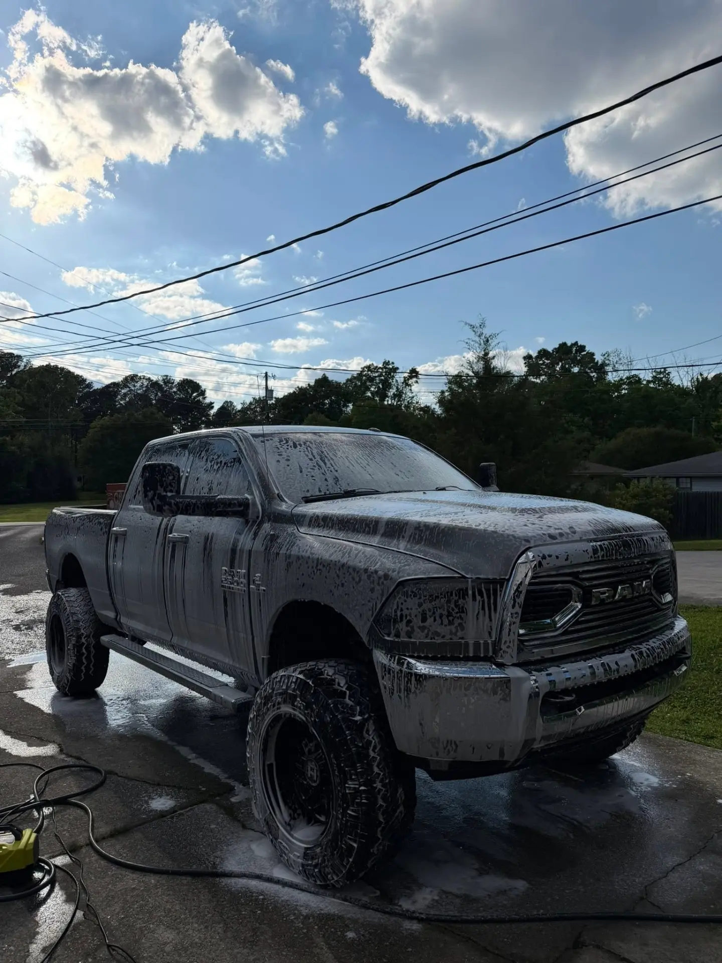 Lifted RAM 2500 covered in cleaning foam — SixPoint Detailing Chattanooga