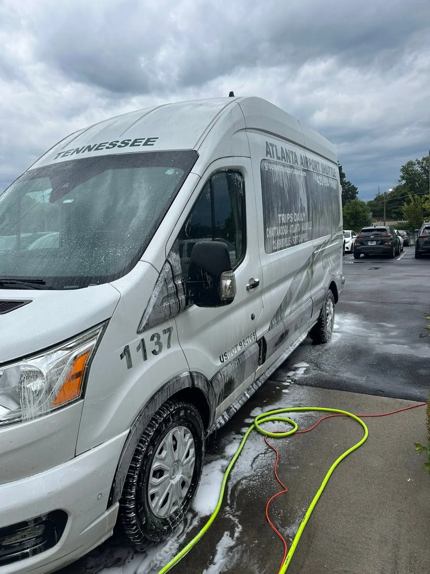Groome Transportation Ford Transit shuttle van during foam wash