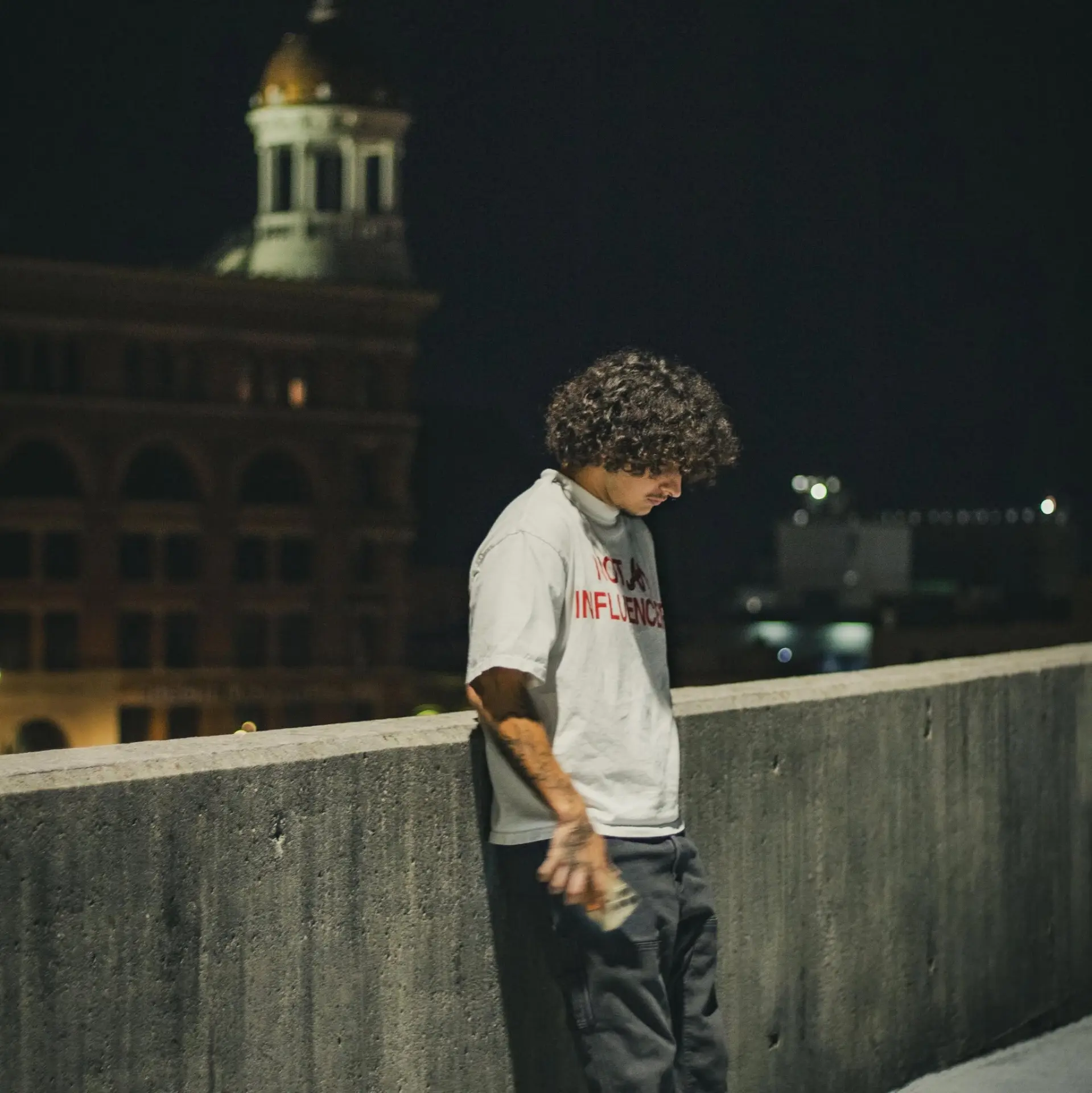 Skyler Robles, owner of SixPoint Detailing, standing on a rooftop at night in downtown Chattanooga