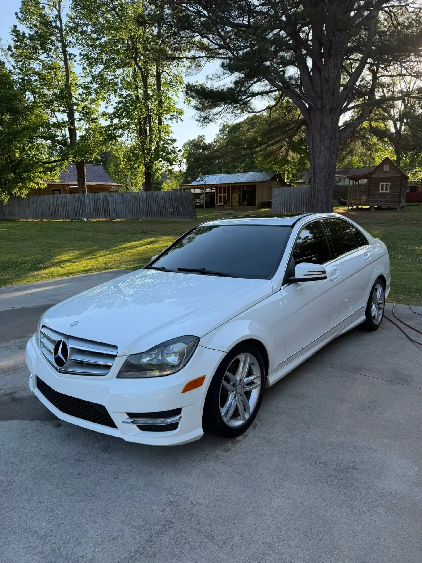White Mercedes-Benz C-Class exterior detail — driveway shot