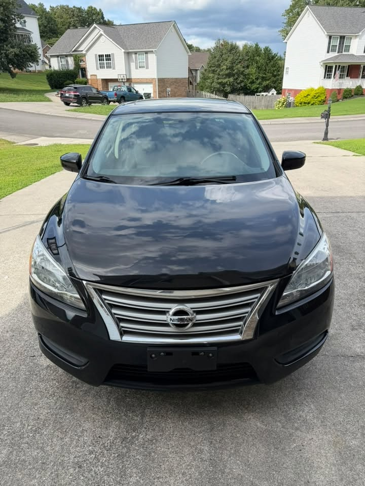 Nissan Sentra front after detail — glossy black finish